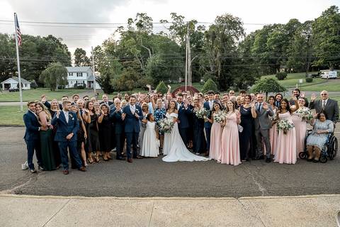 All wedding guests gather in front of the church for a large group photo, celebrating the newlyweds.
Saint Therese Church at North Haven, CT
Vanessa Trettel Photography'