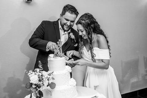 The couple cuts their wedding cake together, smiling as guests cheer during this sweet ceremony moment.
Cascade Fine Catering in Hamden, CT
Vanessa Trettel Photography'