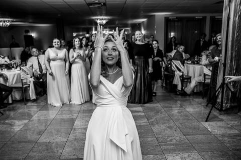 The bride tosses her bouquet as guests gather behind her, ready to catch it in a lively and joyful moment.
Cascade Fine Catering in Hamden, CT
Vanessa Trettel Photography'