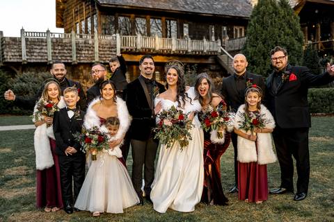 The bridesmaids gather around Laura, their matching bouquets adding pops of color to the soft tones of the castle’s vintage interiors, capturing the bond of love and friendship.'