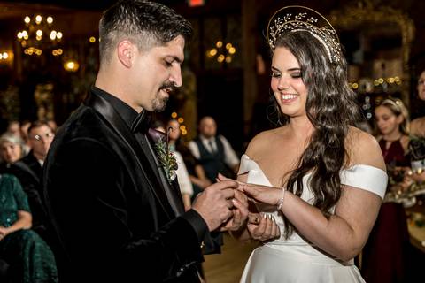 A heartfelt moment as Laura and Lee exchange vows under the soft glow of winter light, surrounded by rustic charm and the warmth of their loved ones in Branford, CT.'