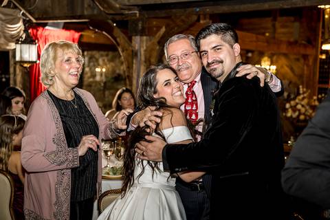 Laura and Lee’s joyful first dance beneath the twinkling lights of Bill Miller's Castle, as their family and friends cheer in the cozy reception hall.
'