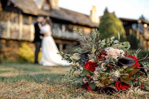 Close-up of Laura’s bouquet resting on a vintage table, with Bill Miller's Castle’s timeless architecture and December’s soft light creating a dreamy wedding atmosphere.'