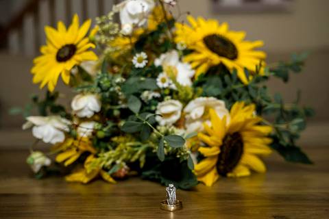 Close-up of a bridal bouquet with an engagement ring tucked into the blooms, resting on a rustic wooden surface in Connecticut.
Vanessa Trettel Photography
Wedding photo at Pavillion on Crystal Lake | Middletown - CT'