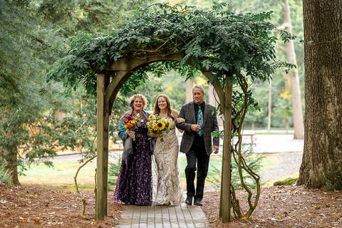 Haily walking toward the altar supported by both her mother and father for her lakeside wedding ceremony.
Vanessa Trettel Photography
Wedding photo at Pavillion on Crystal Lake | Middletown - CT'