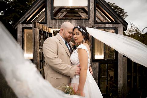 Candid moment of the couple laughing together beside a vintage barn at Angel and Anchor Farm — perfect for a Western-inspired wedding in CT.'