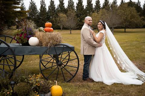 Candid moment of the couple laughing together beside a vintage barn at Angel and Anchor Farm — perfect for a Western-inspired wedding in CT.'