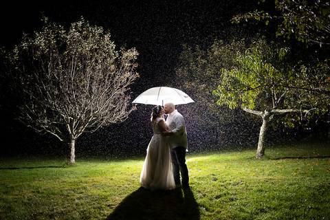 Bride in boots and lace holding hands with her groom — rustic wedding vibes beautifully captured at a scenic farm venue in CT.'