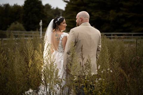 Candid moment of the couple laughing beside a vintage barn at Angel and Anchor Farm — perfect for a rustic wedding in Connecticut.'
