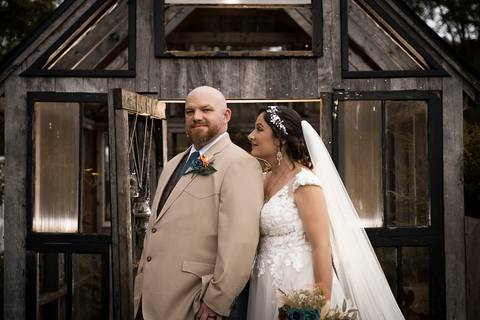 Bride in boots and lace holding hands with her groom — rustic wedding vibes beautifully captured at a scenic farm venue in CT.'