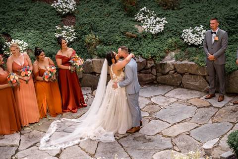 Bruna wipes a tear as Robert smiles during their emotional first look at Heritage Hotel — a magical wedding moment captured in the heart of Connecticut.'