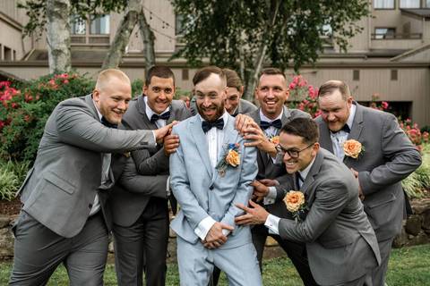 Bruna wipes a tear as Robert smiles during their emotional first look at Heritage Hotel — a magical wedding moment captured in the heart of Connecticut.'