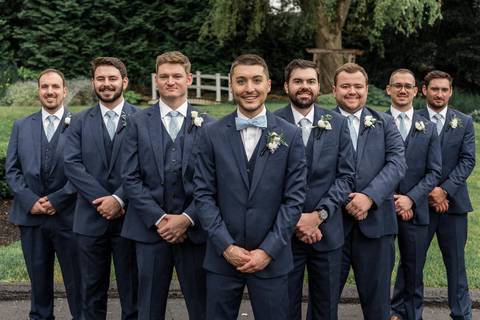 The bridal party bursts into laughter as they pose together, blending elegance with pure fun.'