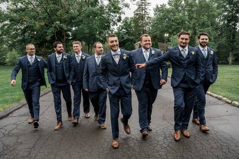 The bridal party bursts into laughter as they pose together, blending elegance with pure fun.'