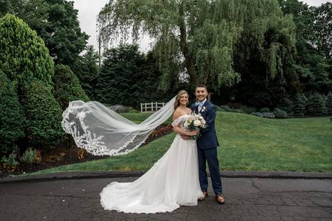 A dreamy sunset portrait of Katelyn and Casey walking hand-in-hand through the garden paths.'