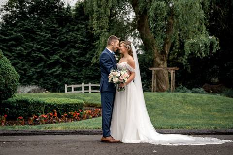 The couple framed by The Woodwinds’ iconic architecture — timeless elegance meets modern romance.'