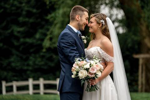 The couple framed by The Woodwinds’ iconic architecture — timeless elegance meets modern romance.'