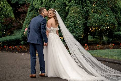 The couple framed by The Woodwinds’ iconic architecture — timeless elegance meets modern romance.'