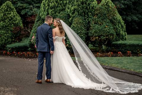 A gentle forehead kiss captured under soft golden light.'