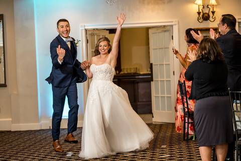 Katelyn and Casey make a grand entrance to cheers and applause, full of excitement and love.'