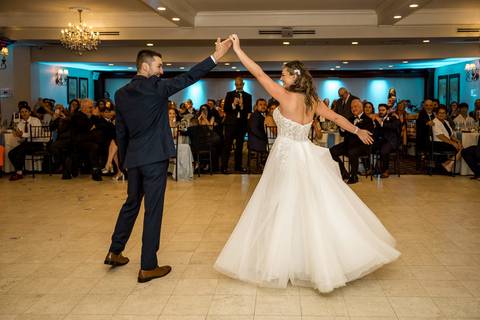 Their first dance as husband and wife, surrounded by glowing lights and smiling faces.'