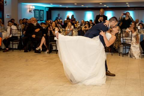 Their first dance as husband and wife, surrounded by glowing lights and smiling faces.'