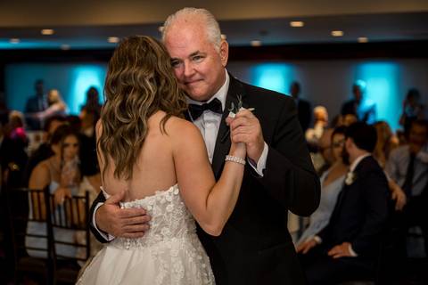 Their first dance as husband and wife, surrounded by glowing lights and smiling faces.'