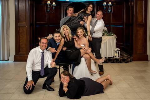 A spontaneous group photo bursting with laughter and movement on the dance floor.'