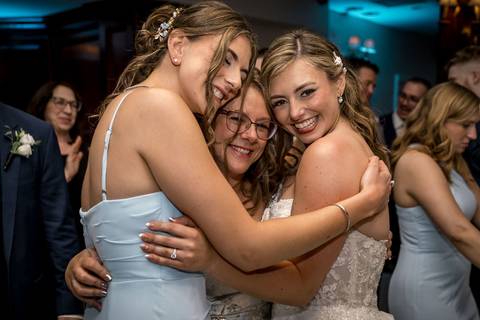 Casey playfully removes the garter as the crowd cheers and laughs.'