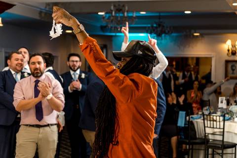 The dance floor packed with energy — guests celebrating with pure happiness.'