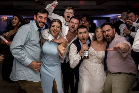 Katelyn and Casey share a carefree dance surrounded by friends — the perfect blend of romance and fun.'