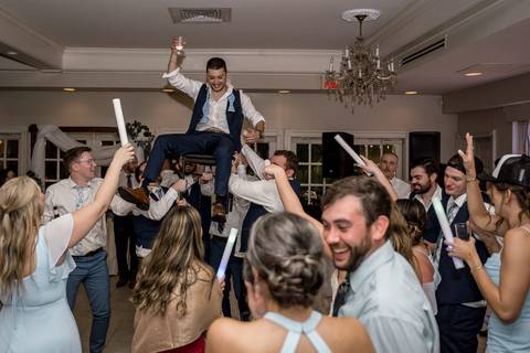 Katelyn and Casey share a carefree dance surrounded by friends — the perfect blend of romance and fun.'