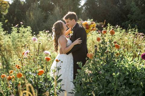 The couple framed by the farm’s open fields and dramatic sky, an artistic capture of rustic charm in Durham, CT.'