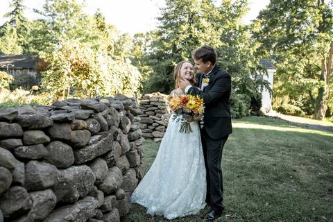 A quiet moment with family pictures, capturing natural smiles and tender embraces at a farm wedding in Durham, CT'