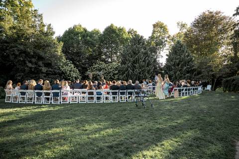 The groom’s entrance captures his confident smile as he walks down the aisle, surrounded by loved ones at Gastler Farm.'