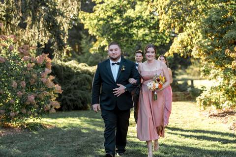 The groomsmen make a joyful entrance down the aisle, bringing smiles and excitement to Courtney & Rob’s summer wedding at Gastler Farm in Durham, CT.'