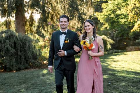 Guests cheer as the groomsmen and bridesmaids enter, setting the tone for a fun and heartfelt ceremony at Gastler Farm.'