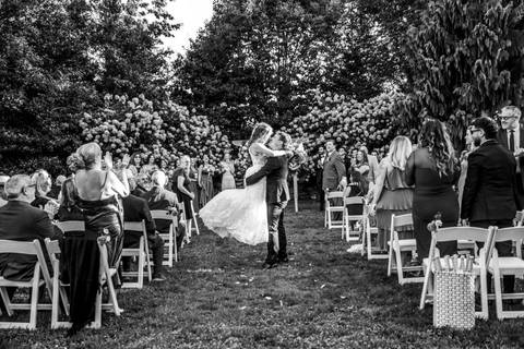A romantic first kiss as husband and wife, set against the rustic charm of Gastler Farm’s fields on a sunny CT afternoon.'