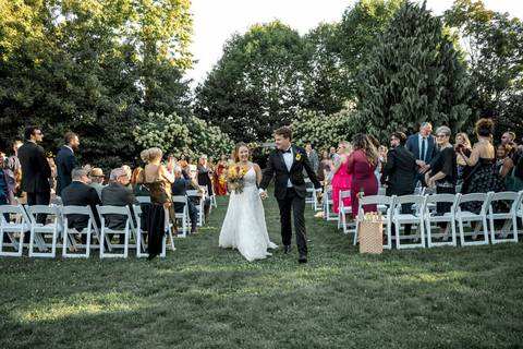 A romantic first kiss as husband and wife, set against the rustic charm of Gastler Farm’s fields on a sunny CT afternoon.'