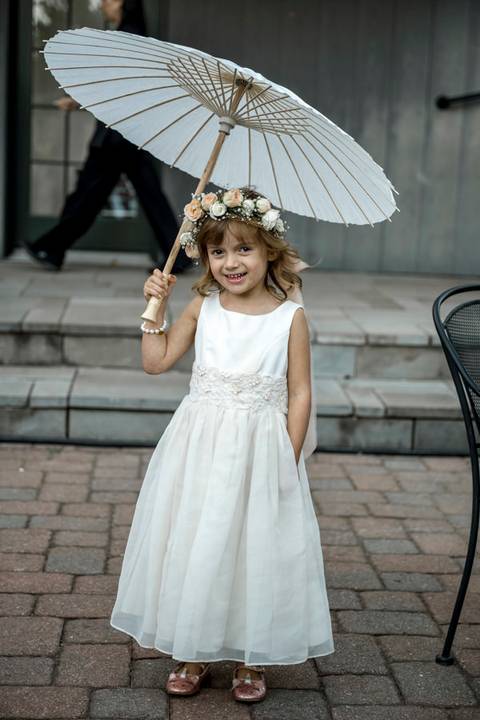 Newlyweds raise their glasses during a joyful wedding toast, celebrating love and laughter with family and friends.'