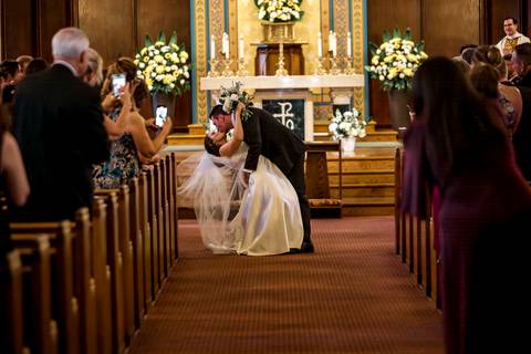 The couple exits the church, smiling widely as guests cheer. The energy shifts from emotional to celebratory, with movement and joy filling the frame.
Vanessa Trettel Photography'
