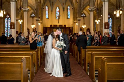 A third frame of their exit shows guests reaching out, confetti in the air, and a sense of community surrounding them in celebration.
Vanessa Trettel Photography'