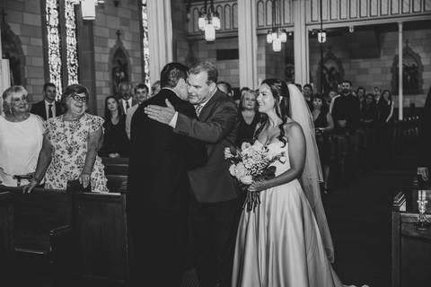 In a black and white frame, the bride’s father embraces the groom tightly. It’s a powerful exchange—gratitude, trust, and love all captured in a single, heartfelt gesture before the ceremony continues.
Vanessa Trettel Photography'