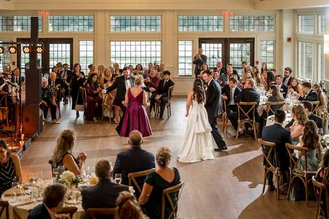 The couple dances with their mothers, sharing emotional, heartfelt moments surrounded by loved ones.
Vanessa Trettel Photography'