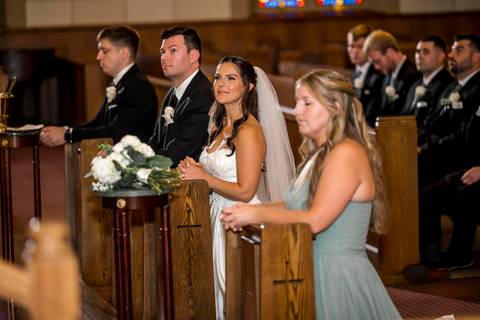 The bride stands beside her maid of honor and best man, sharing a quiet, joyful glance. Their presence reflects support and friendship, grounding the moment in connection and shared history.
Vanessa Trettel Photography'