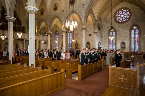 The couple stands at the altar, facing forward, framed by the church’s elegant interior. Their expressions are calm yet emotional, fully present in the moment they’ve been waiting for.
Vanessa Trettel Photography'
