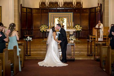 A second angle of the first kiss shows a closer, more emotional perspective—hands gently holding, eyes closed, fully immersed in love and celebration.
Vanessa Trettel Photography'