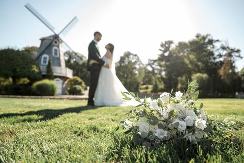 The newlyweds walking hand-in-hand across the beautiful Aqua Turf Club grounds in Plantsville, CT. Perfect backdrop for a summer wedding.'