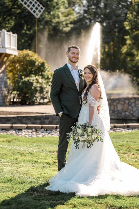 Artistic couple portraits: Jeffrey & Kiara stealing a kiss while strolling through the stunning Aqua Turf Club garden. Pure romance in Plantsville, CT.'