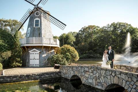 Artistic couple portraits: Jeffrey & Kiara stealing a kiss while strolling through the stunning Aqua Turf Club garden. Pure romance in Plantsville, CT.'